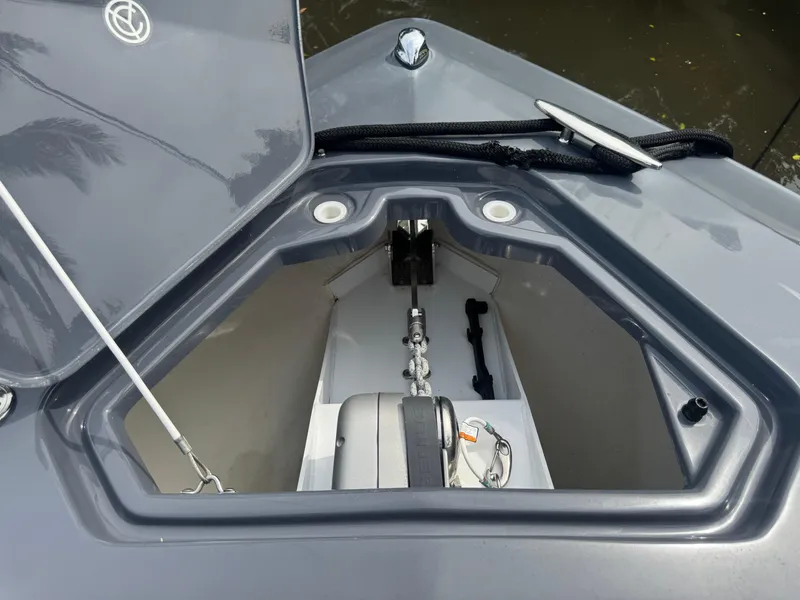 Slide: The Image of 2021 Cruisers Yachts 338 South Beach Edition Bow Rider anchor compartment, open lid view. - 37