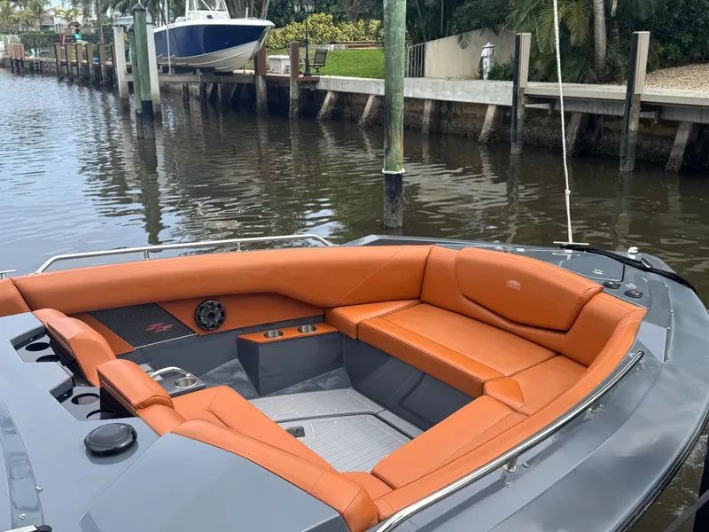 Slide: The Image of 2021 Cruisers Yachts 338 South Beach Edition Bow Rider with orange seating, docked by a canal. - 43