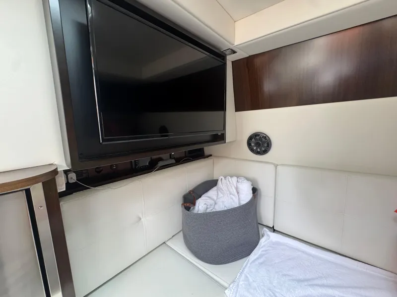 Slide: The Image of Interior of 2021 Cruisers Yachts 338 South Beach Edition, featuring TV and seating area. - 47