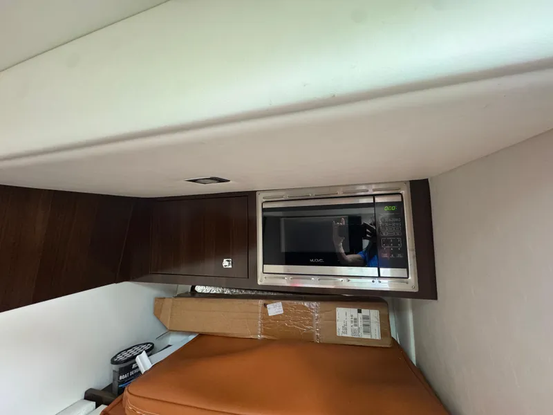 Slide: The Image of 2021 Cruisers Yachts 338 South Beach Edition interior with microwave and storage area. - 48