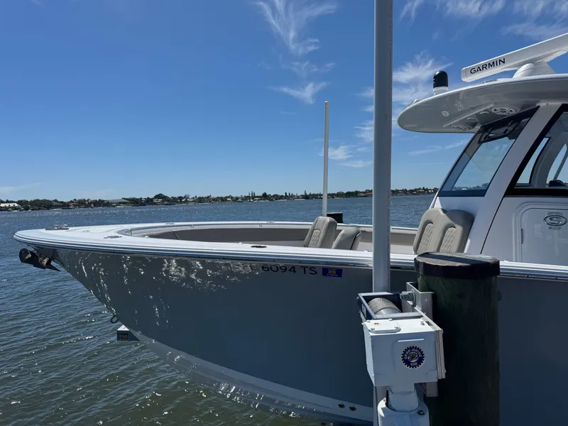Slide: The Image of 2024 Sportsman 302 boat docked on a sunny day with clear blue skies. - 10