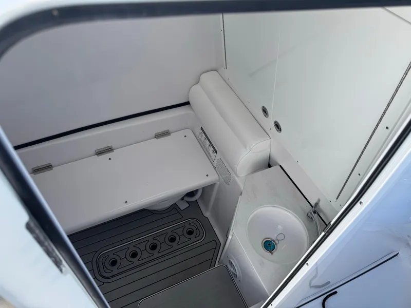 Slide: The Image of 2024 Sportsman 302 boat interior with compact bathroom and sink. - 3