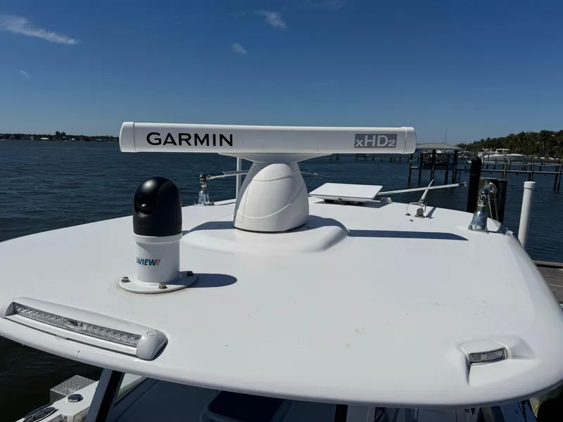 Slide: The Image of 2024 Sportsman 302 boat with Garmin xHD2 radar on deck, docked by the water. - 4