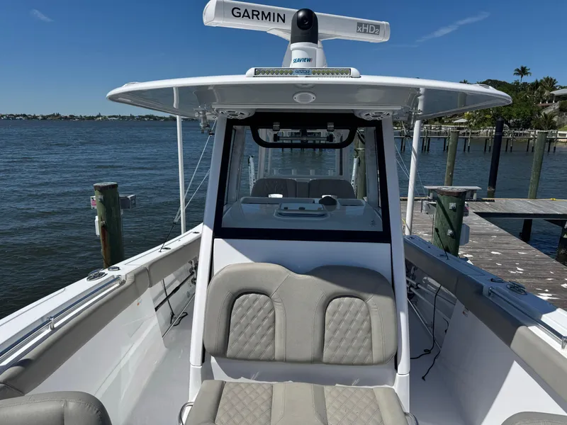 Slide: The Image of 2024 Sportsman 302 boat with Garmin radar, docked by the water. - 8