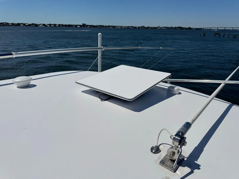 Slide: The Image of 2024 Sportsman 302 boat with satellite dish on deck, overlooking calm waters. - 9