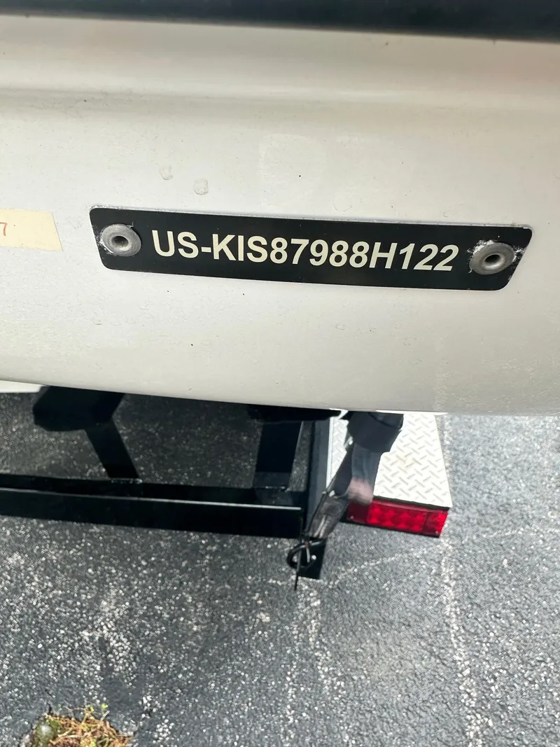 Slide: The Image of 2023 Crownline 240 SS boat with visible hull identification number on trailer. - 11