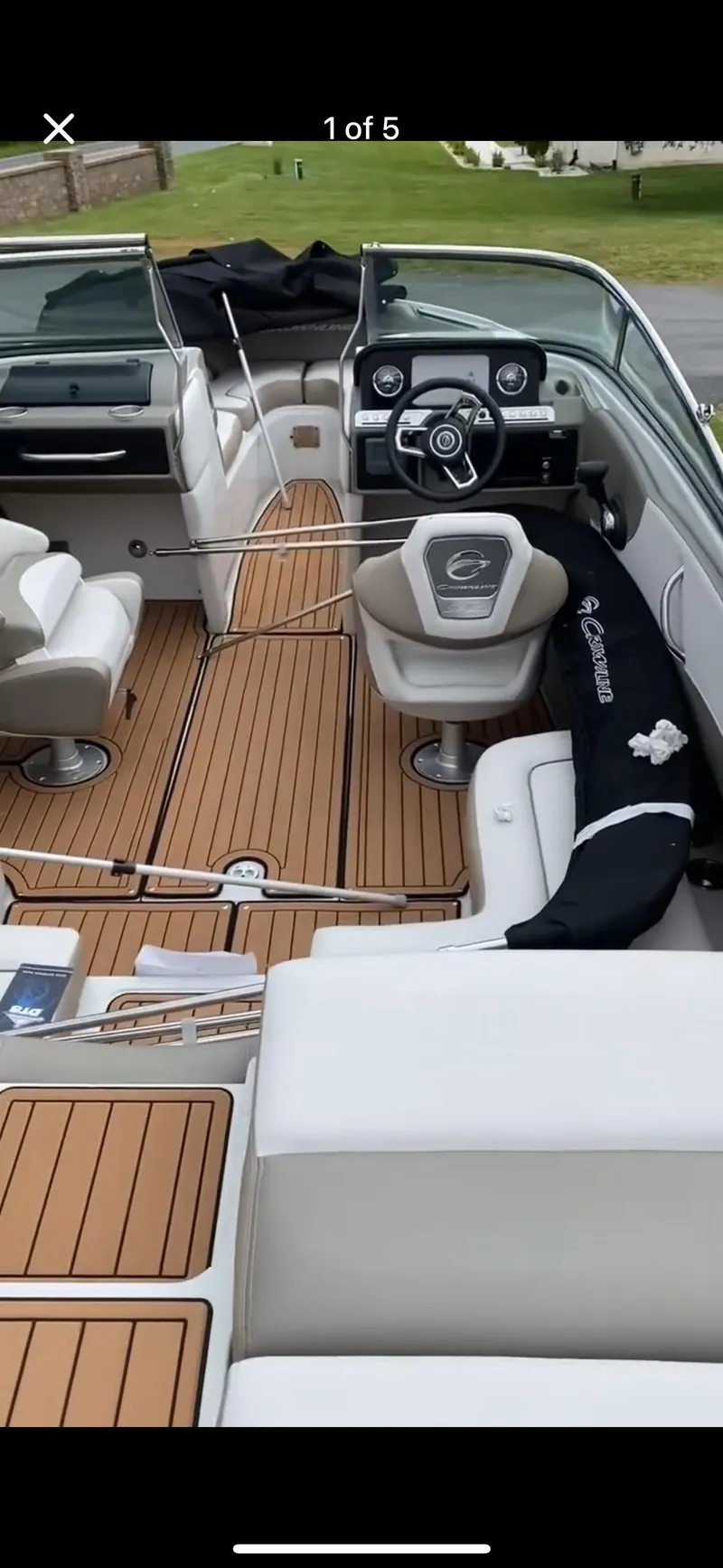 Slide: The Image of 2023 Crownline 240 SS boat interior with teak flooring and modern dashboard. - 12