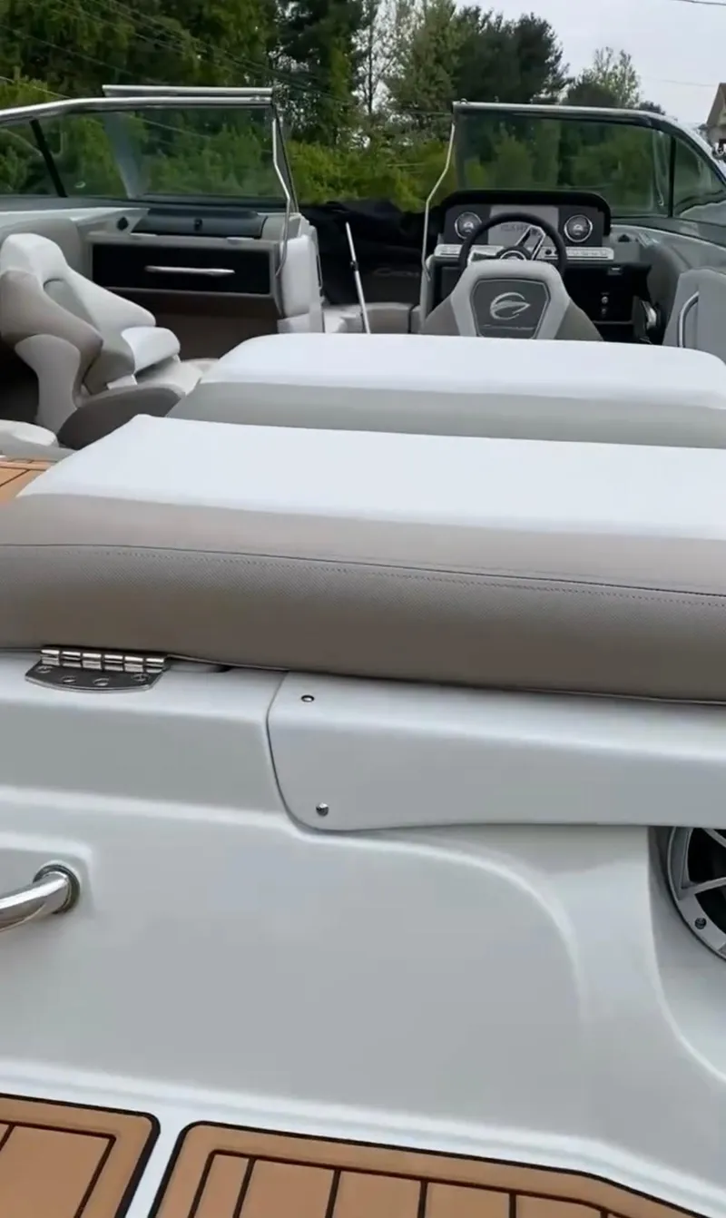 Slide: The Image of 2023 Crownline 240 SS boat interior with sleek seating and modern dashboard design. - 13