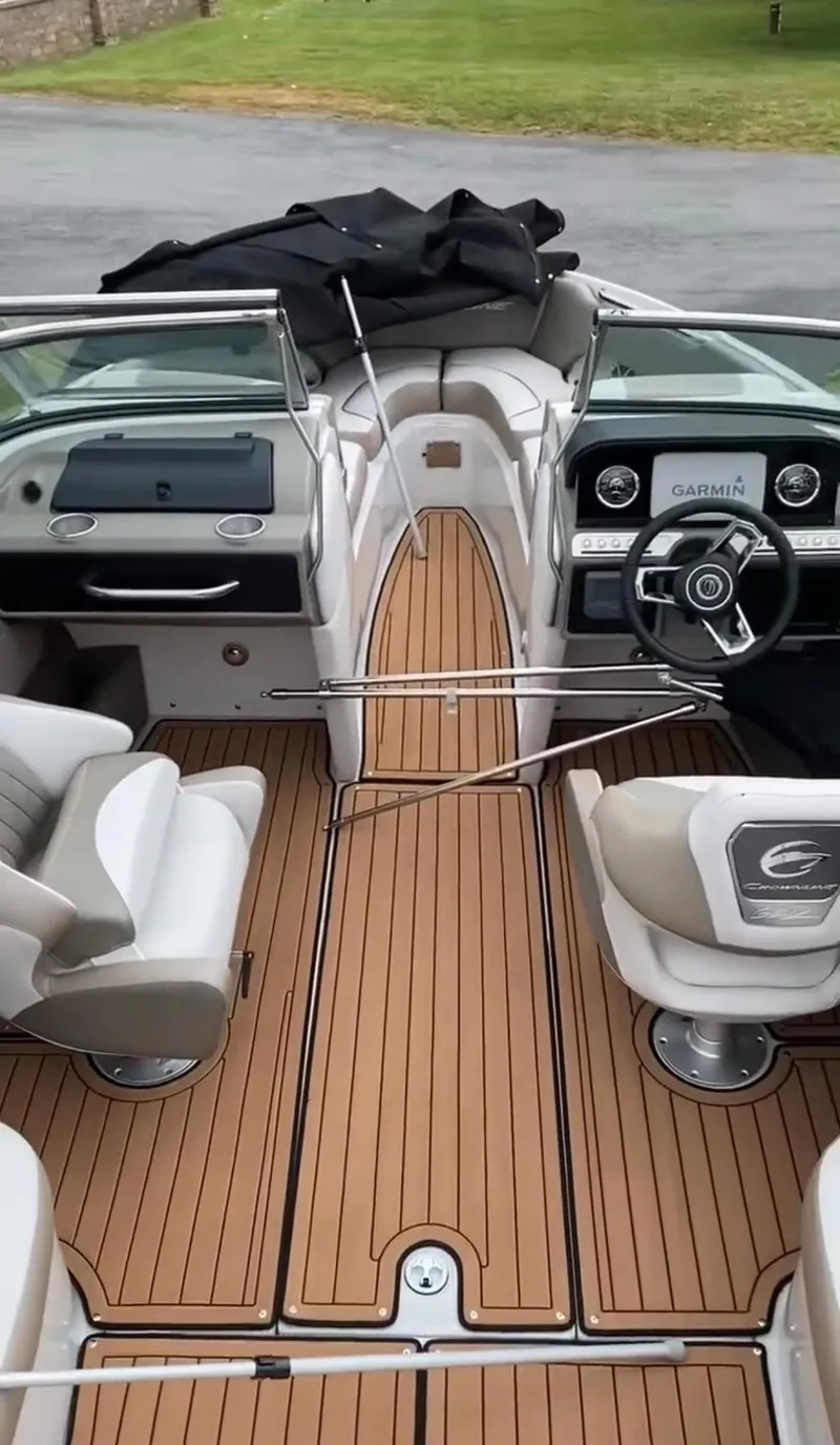Slide: The Image of 2023 Crownline 240 SS boat interior with modern dashboard and teak flooring. - 15