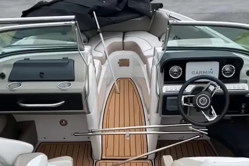 Slide: The Image of 2023 Crownline 240 SS boat interior with Garmin navigation system and sleek design. - 17