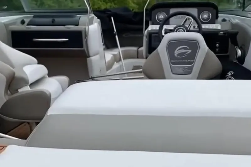 Slide: The Image of 2023 Crownline 240 SS boat interior with modern dashboard and seating. - 18