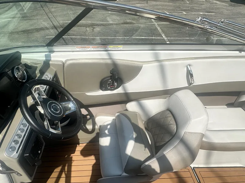 Slide: The Image of 2023 Crownline 240 SS boat interior with steering wheel and seating, featuring modern design elements. - 20