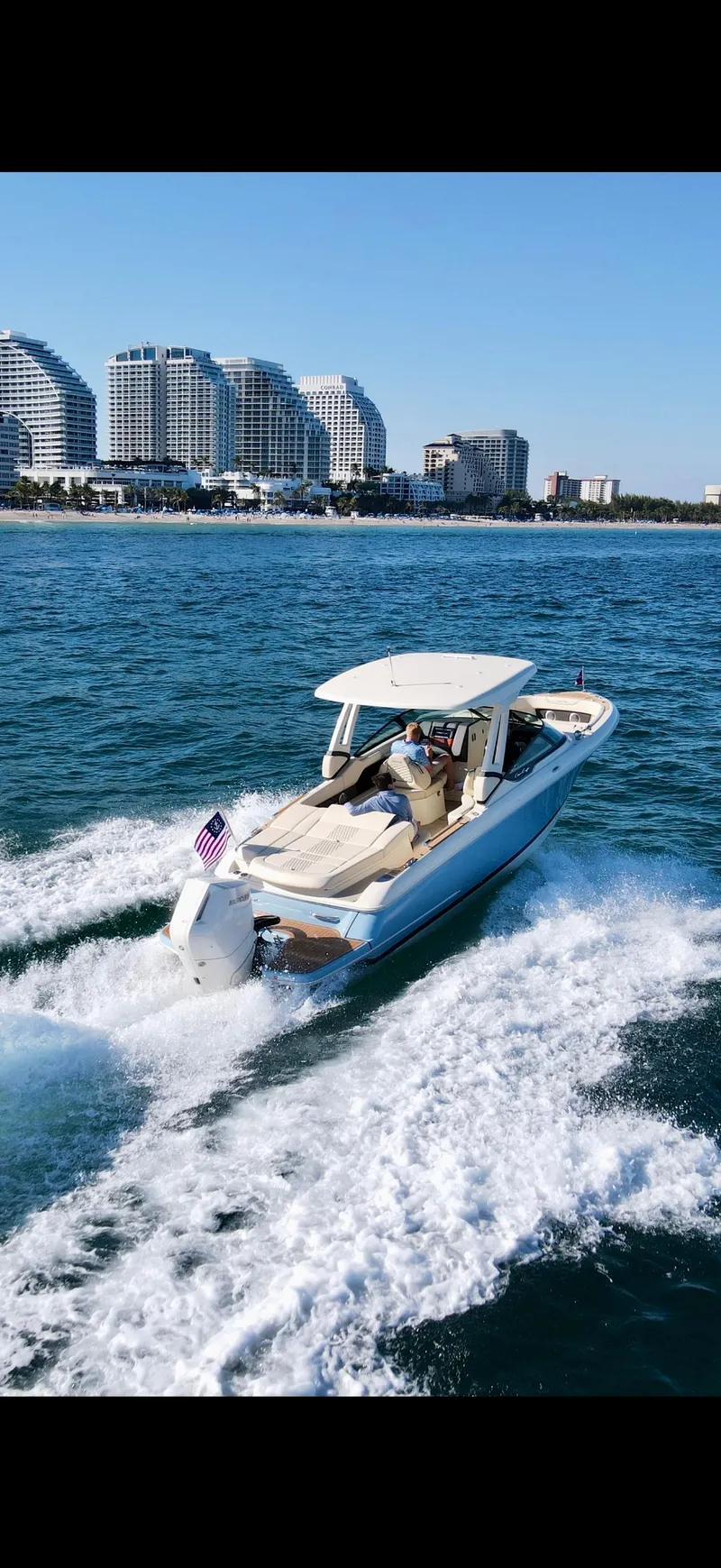 The Image of 2025 Chris-Craft Sportster 28 cruising on ocean near city skyline. - 1