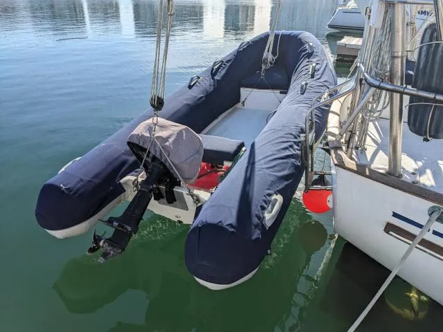 Slide: The Image of Inflatable boat with motor docked beside a 1981 Kelly Peterson 44 sailboat. - 13