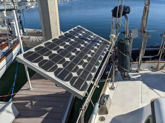 Slide: The Image of Solar panel on 1981 Kelly Peterson 44 sailboat docked by the water. - 15