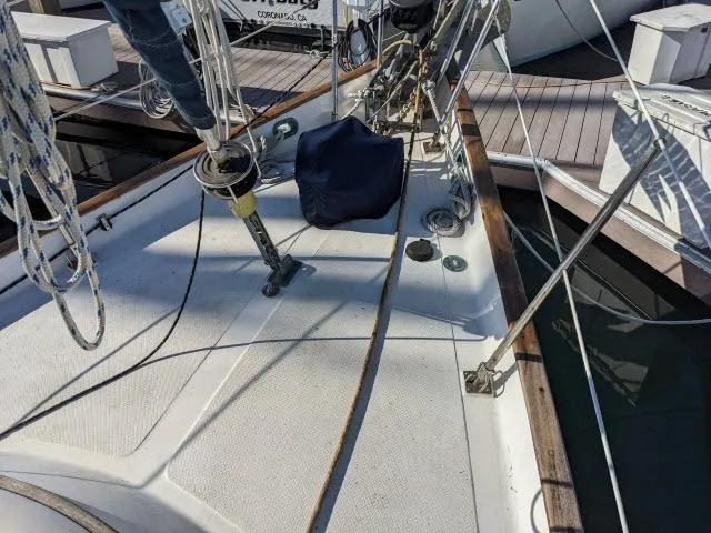 Slide: The Image of Deck view of a 1981 Kelly Peterson 44 sailboat docked at a marina. - 17