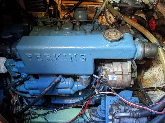 Slide: The Image of Perkins engine in a 1981 Kelly Peterson 44 sailboat, showcasing detailed mechanical components. - 20