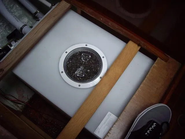 Slide: The Image of 1981 Kelly Peterson 44 yacht component, featuring a secured tank with visible piping and wooden framing. - 22