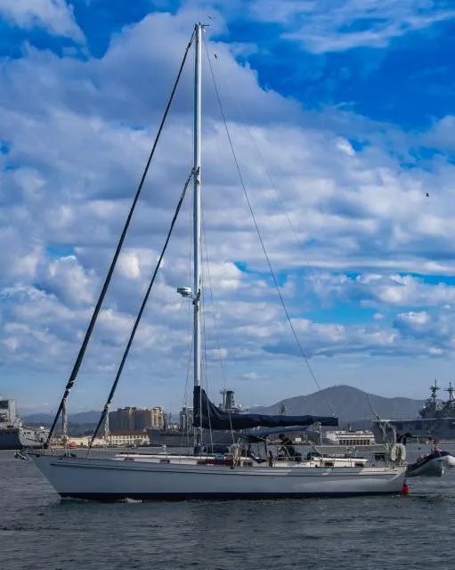 Slide: The Image of 1981 Kelly Peterson 44 sailboat on water under blue sky with clouds. - 25