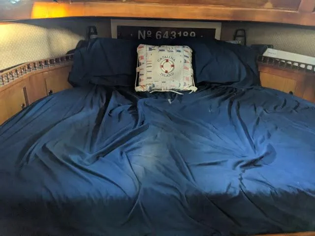Slide: The Image of Cozy cabin bed in 1981 Kelly Peterson 44 sailboat with nautical-themed pillow. - 9
