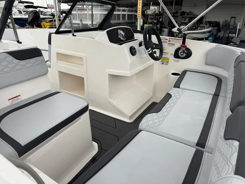 Slide: The Image of 2025 Bayliner Element M17 boat interior with modern seating and steering console. - 2