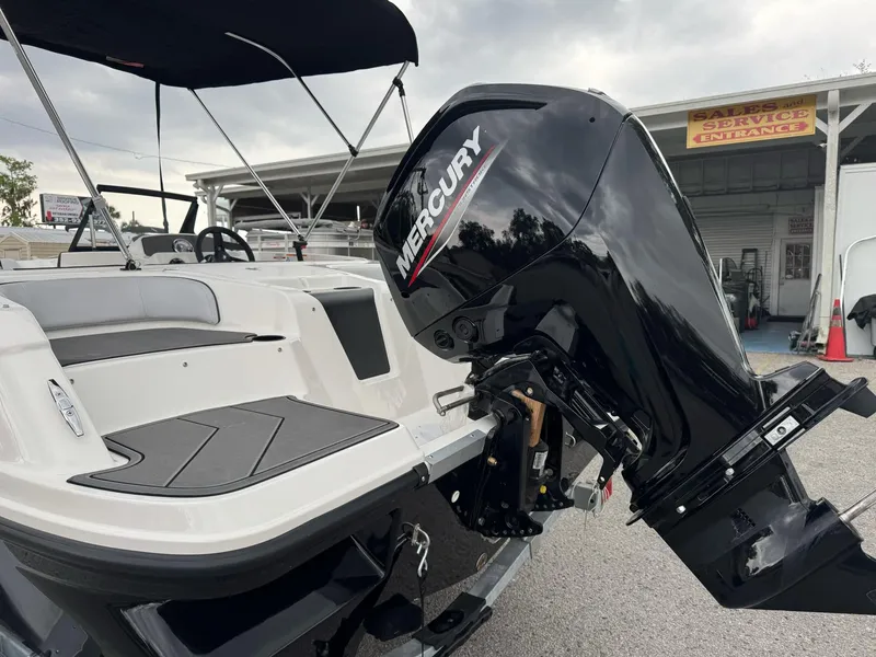 Slide: The Image of 2025 Bayliner Element M17 boat with Mercury outboard motor, parked outdoors. - 6