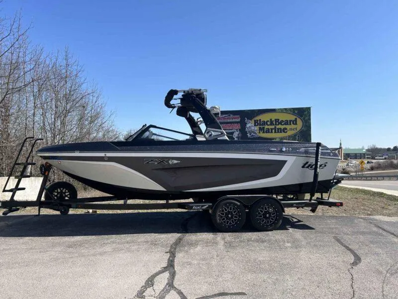 Slide: The Image of 2021 Tigé 23ZX boat on trailer at BlackBeard Marine dealership. - 0