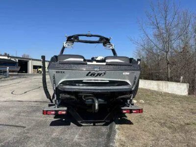 Slide: The Image of 2021 Tigé 23ZX boat rear view on a trailer, parked outdoors. - 3
