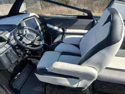 Slide: The Image of 2021 Tigé 23ZX boat interior with modern steering and comfortable seating. - 9