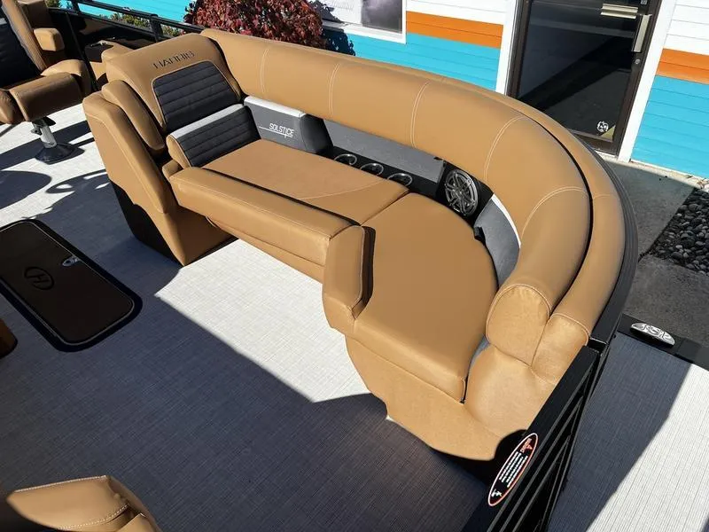 Slide: The Image of 2024 Harris Solstice 230 boat interior with tan seating and modern design. - 11