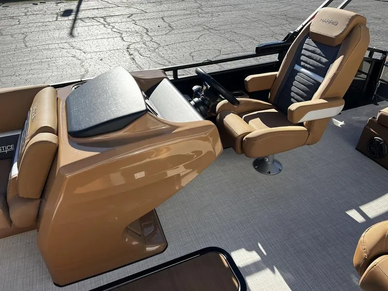 Slide: The Image of 2024 Harris Solstice 230 boat interior with luxurious captain's chair and sleek dashboard design. - 13
