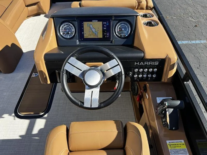 Slide: The Image of 2024 Harris Solstice 230 boat dashboard with steering wheel and navigation display. - 15