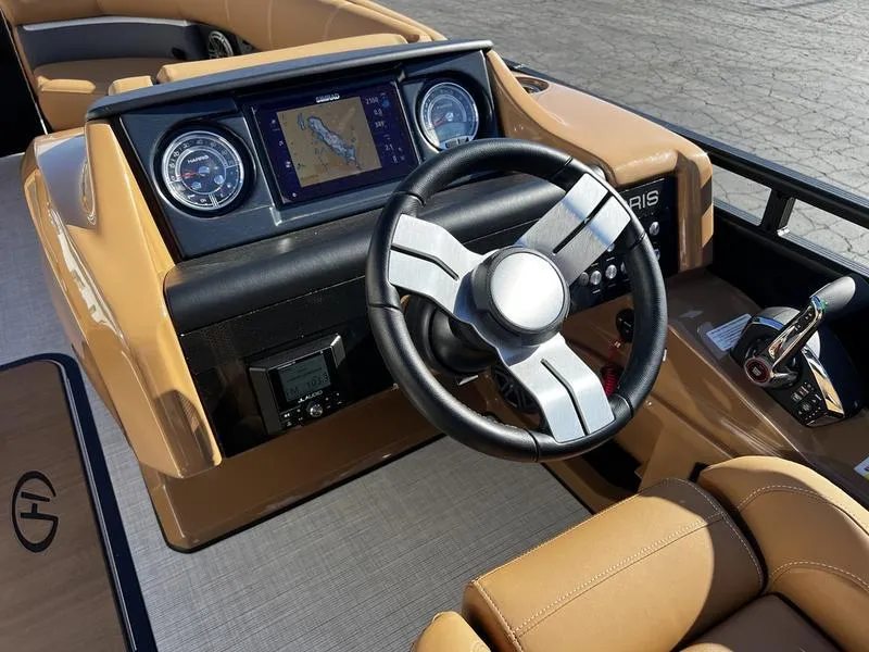 Slide: The Image of 2024 Harris Solstice 230 dashboard with steering wheel, gauges, and navigation screen. - 16