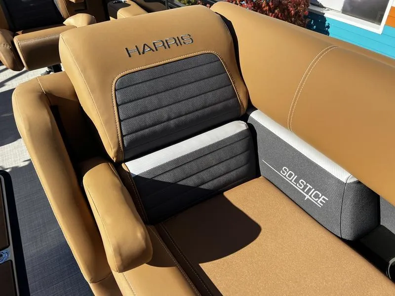 Slide: The Image of 2024 Harris Solstice 230 boat seating with tan and black upholstery. - 19