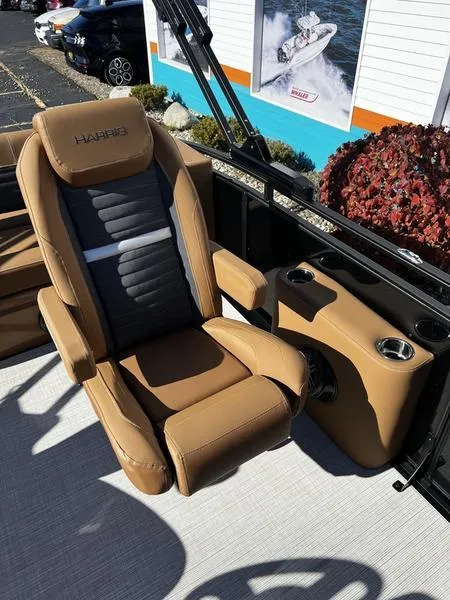 Slide: The Image of 2024 Harris Solstice 230 boat seat with tan and black upholstery, cup holders, and sleek design. - 20