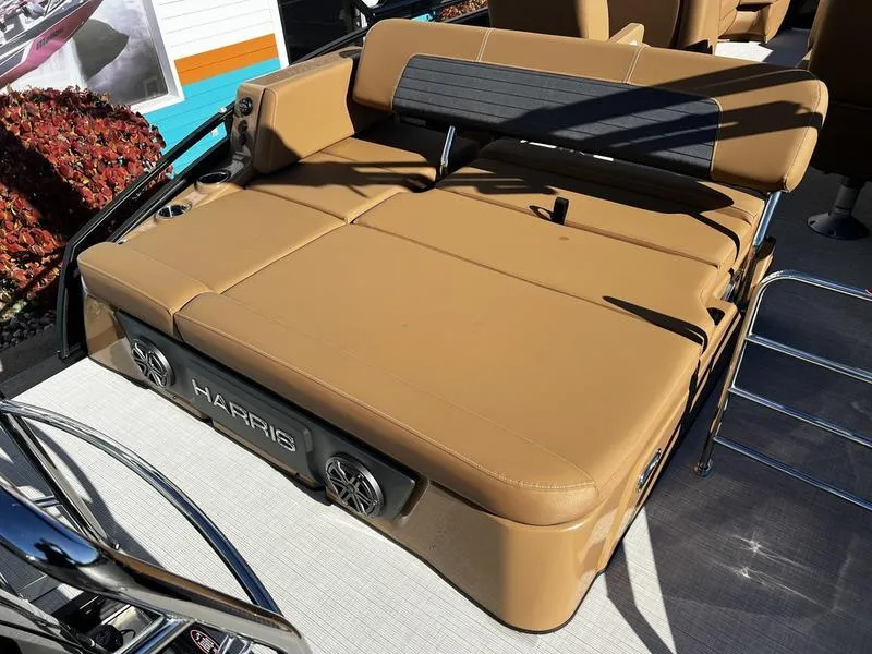Slide: The Image of 2024 Harris Solstice 230 boat with tan seating and integrated speakers. - 21