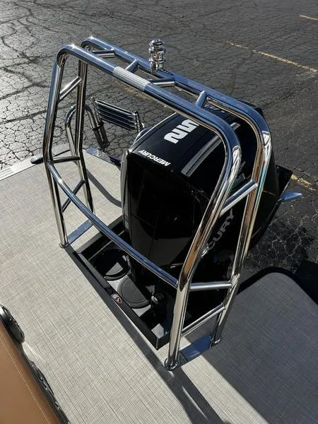 Slide: The Image of 2024 Harris Solstice 230 boat with Mercury engine and sleek chrome railing. - 23