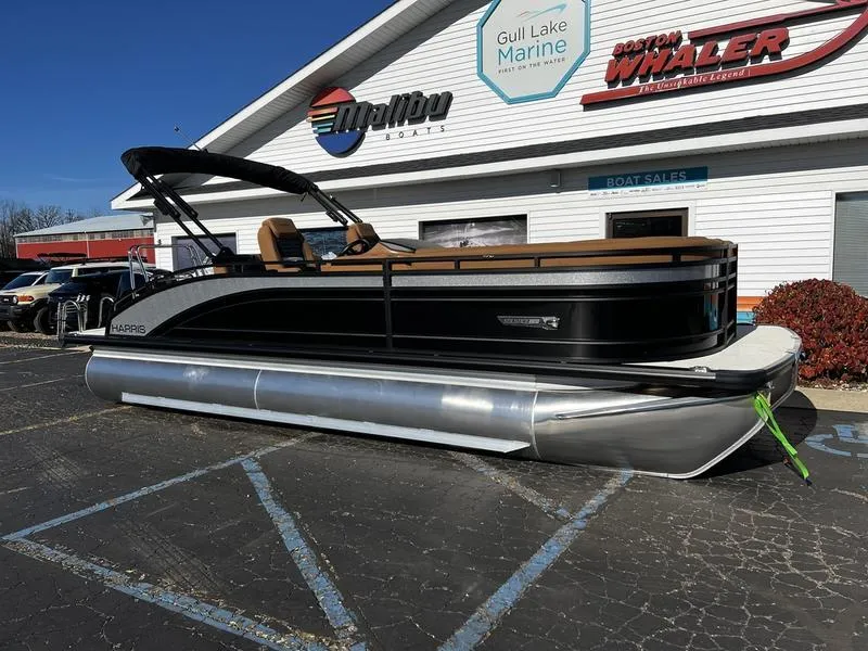 Slide: The Image of 2024 Harris Solstice 230 pontoon boat displayed at a marine dealership. - 3