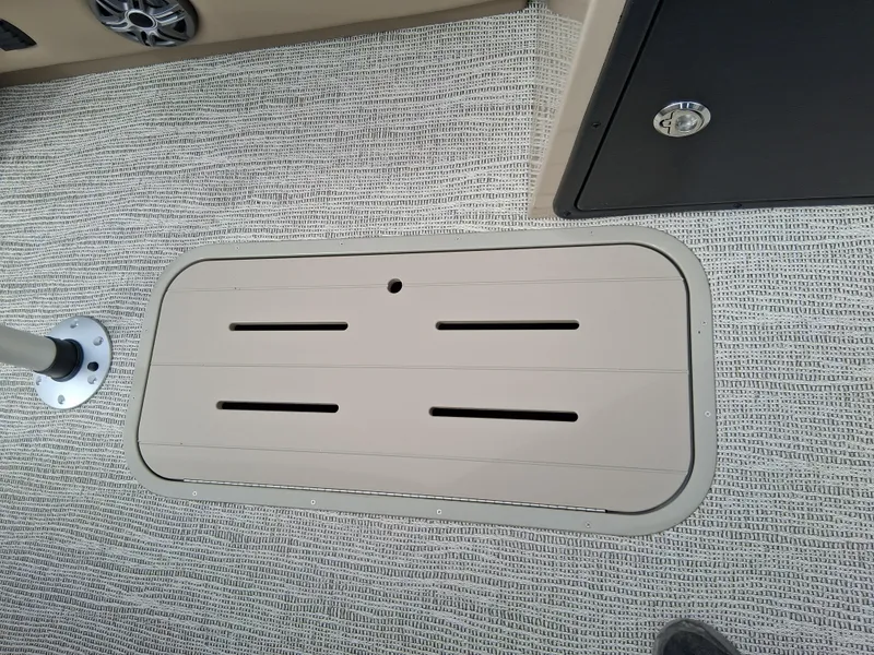Slide: The Image of Floor hatch on 2025 SunCatcher Select 324RC boat, featuring textured flooring and secure latch. - 10