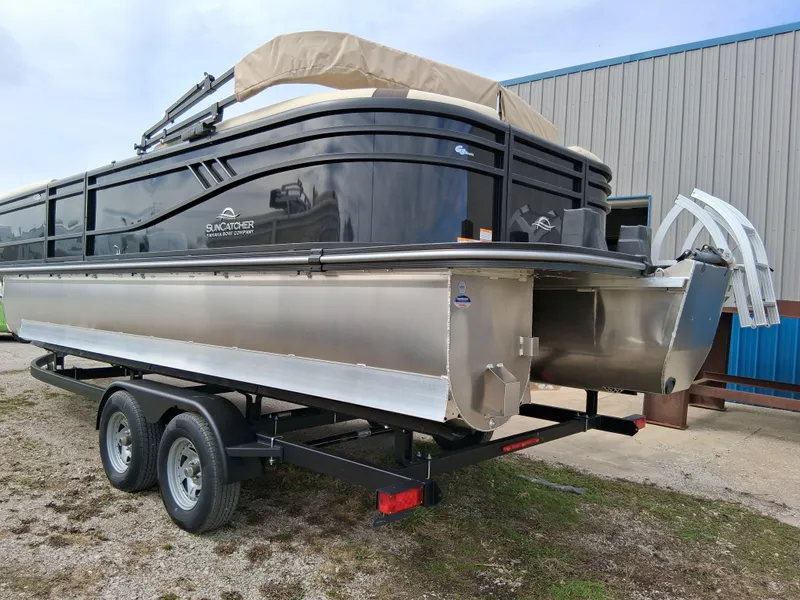 Slide: The Image of 2025 SunCatcher Select 324RC pontoon boat on trailer, parked outdoors. - 3