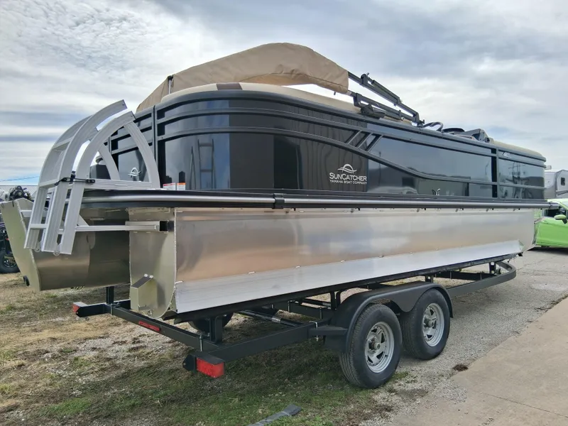 Slide: The Image of 2025 SunCatcher Select 324RC pontoon boat on trailer, parked outdoors. - 4
