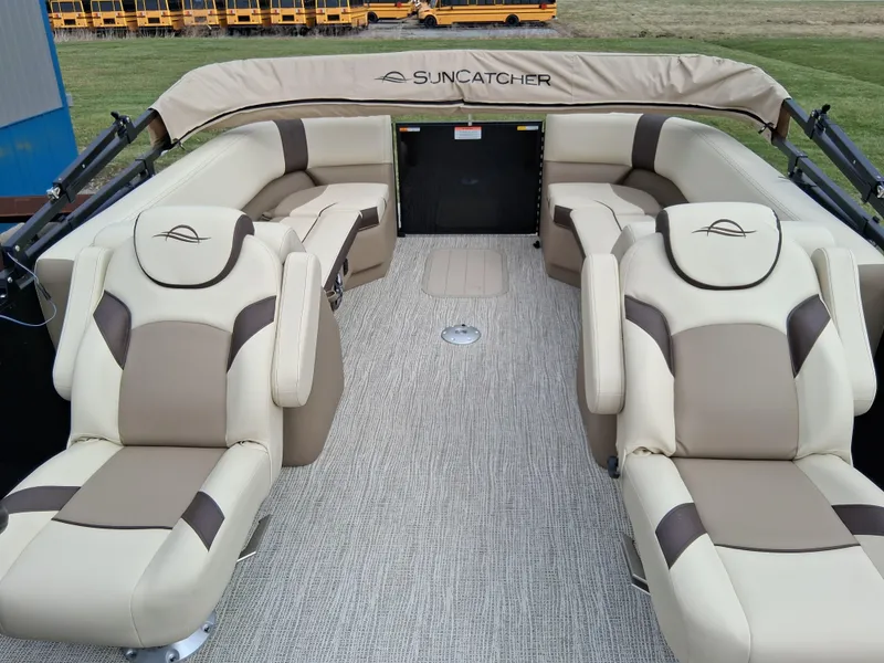 Slide: The Image of 2025 SunCatcher Select 324RC pontoon boat with luxurious beige seating and spacious layout. - 6