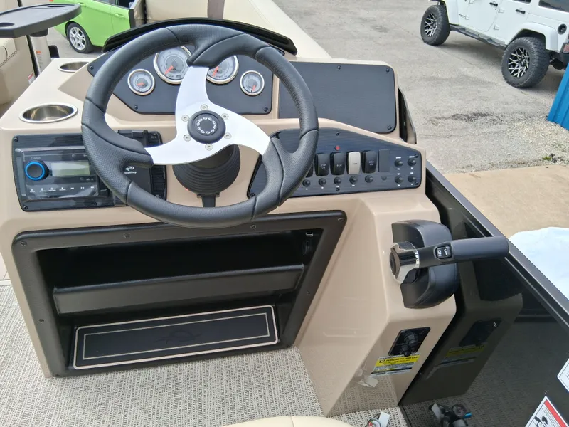 Slide: The Image of Steering console of 2025 SunCatcher Select 324RC boat with modern controls and dashboard. - 7