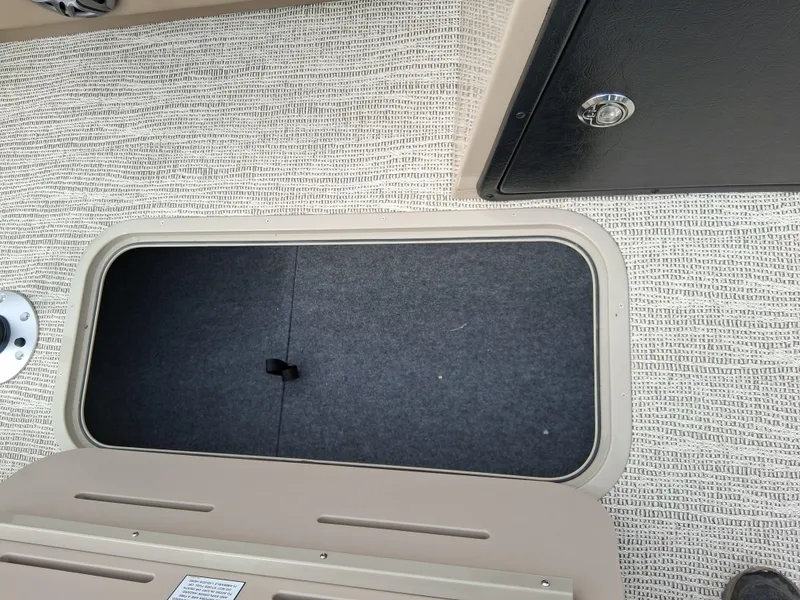 Slide: The Image of Open storage compartment on 2025 SunCatcher Select 324RC boat deck. - 9