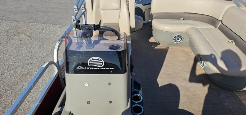 Slide: The Image of 2024 Sun Tracker BB-18 boat interior with beige seating and control console. - 10