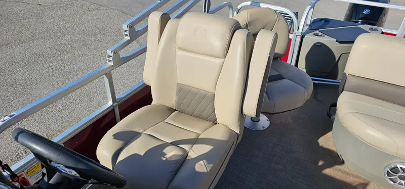 Slide: The Image of 2024 Sun Tracker BB-18 boat interior with beige seating and steering wheel. - 12