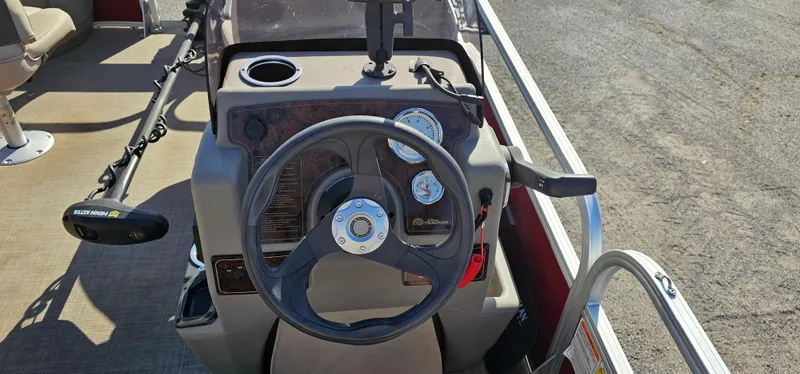Slide: The Image of 2024 Sun Tracker BB-18 boat dashboard with steering wheel and control panel. - 13