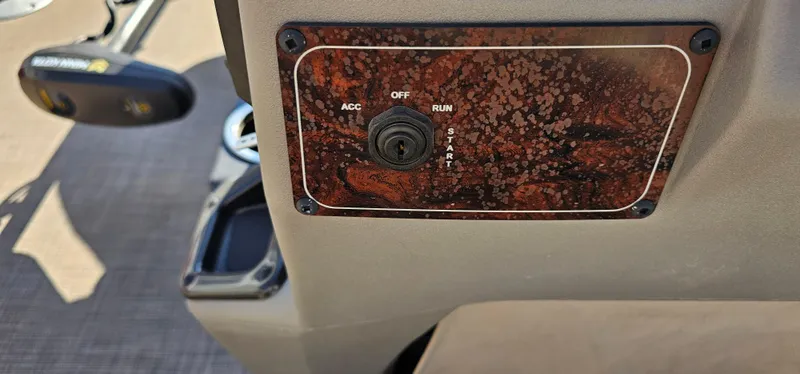 Slide: The Image of 2024 Sun Tracker BB-18 ignition panel with key switch and control settings. - 14