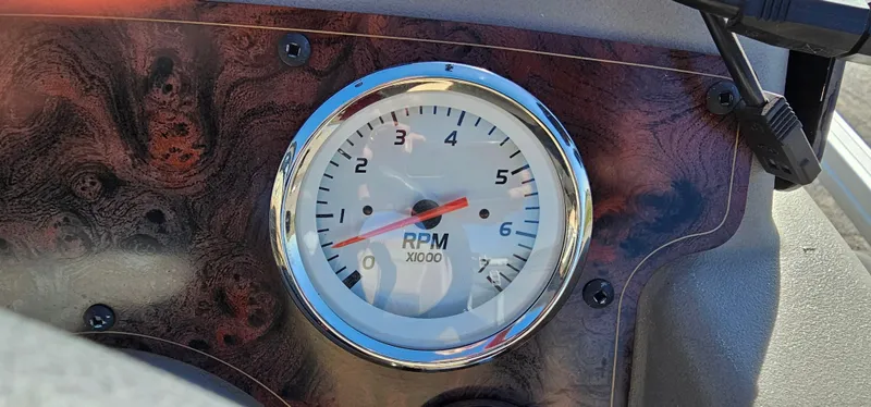 Slide: The Image of Tachometer of 2024 Sun Tracker BB-18 boat, displaying RPM on a wood-grain dashboard. - 15