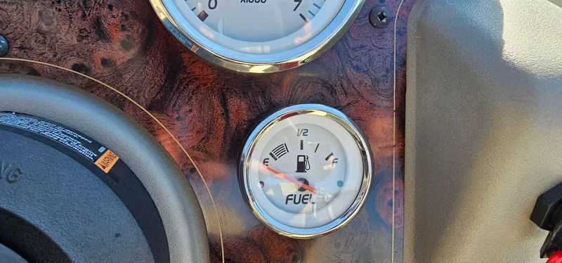 Slide: The Image of 2024 Sun Tracker BB-18 dashboard with fuel gauge and speedometer. - 16